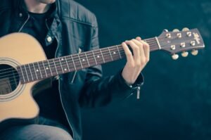 Um homem tocando violão Um homem, um violão, a arte A canção "Rosa Negra" é uma bela composição de Ranne Ramos. Divulgue a sua obra.
